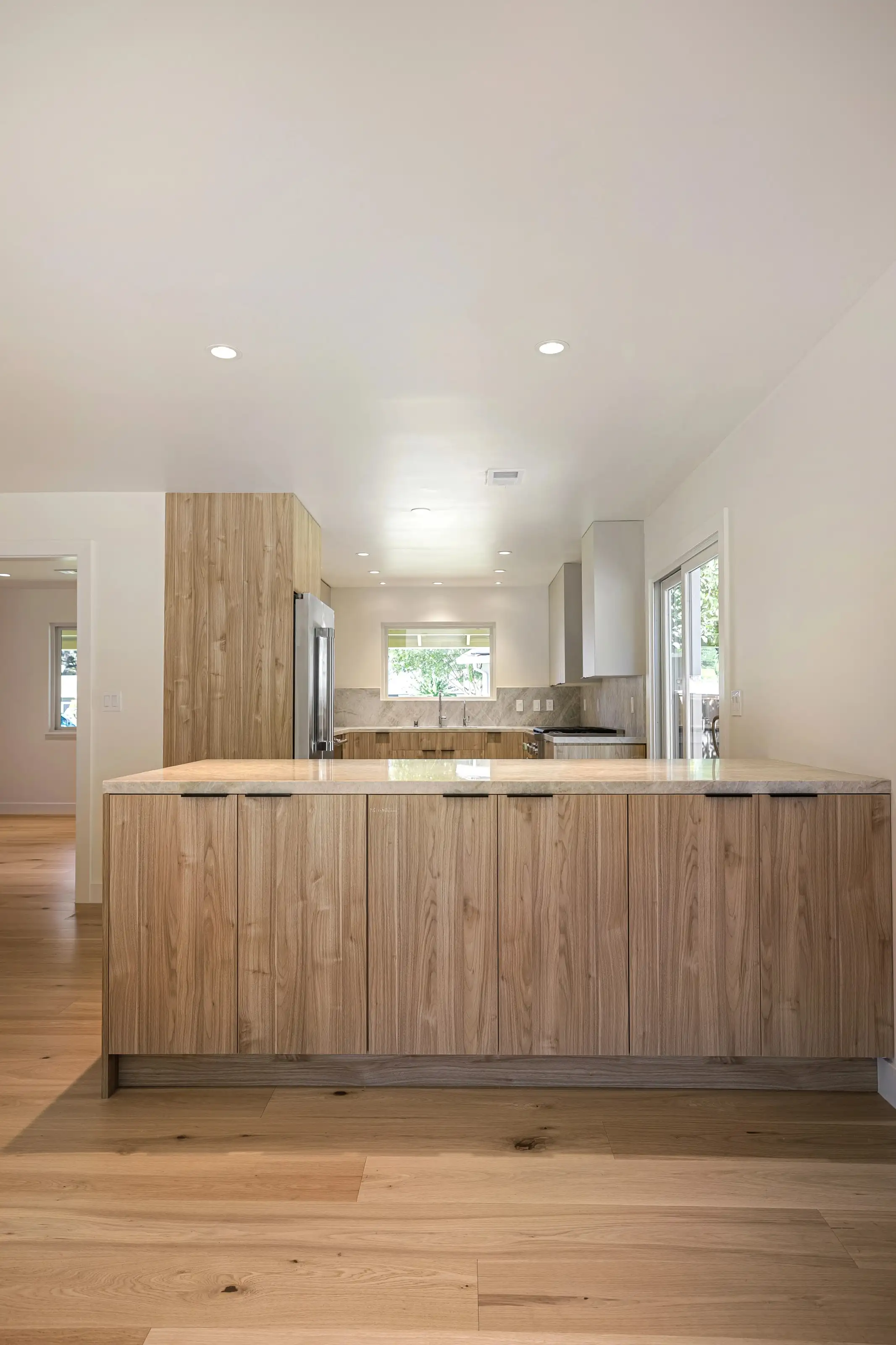 itchen remodeling project in San Jose showcasing a modern island design with light wood finish and stone countertops.
