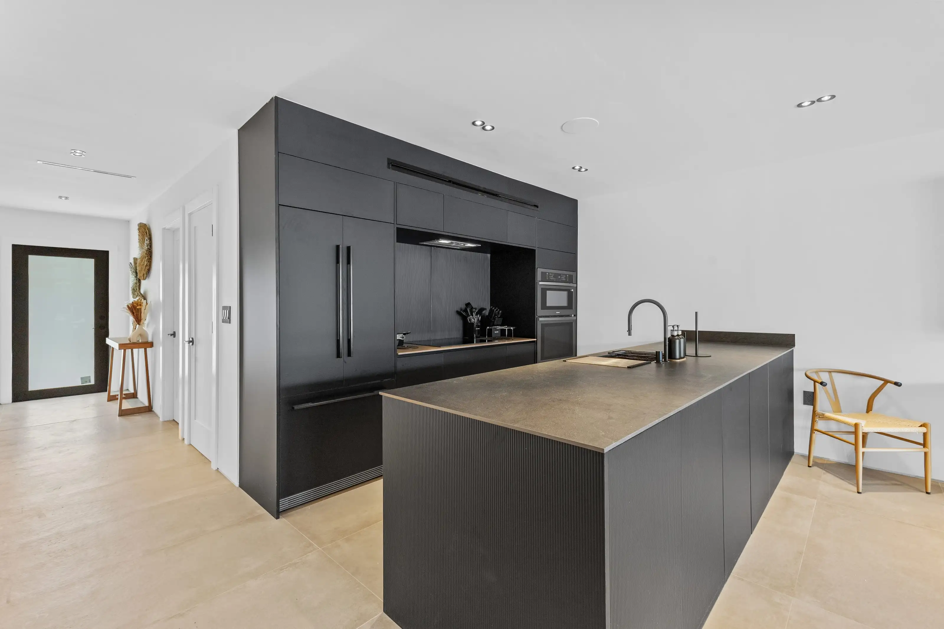 Elegant white and wood kitchen renovation in San Jose with marble backsplash and brass fixtures.