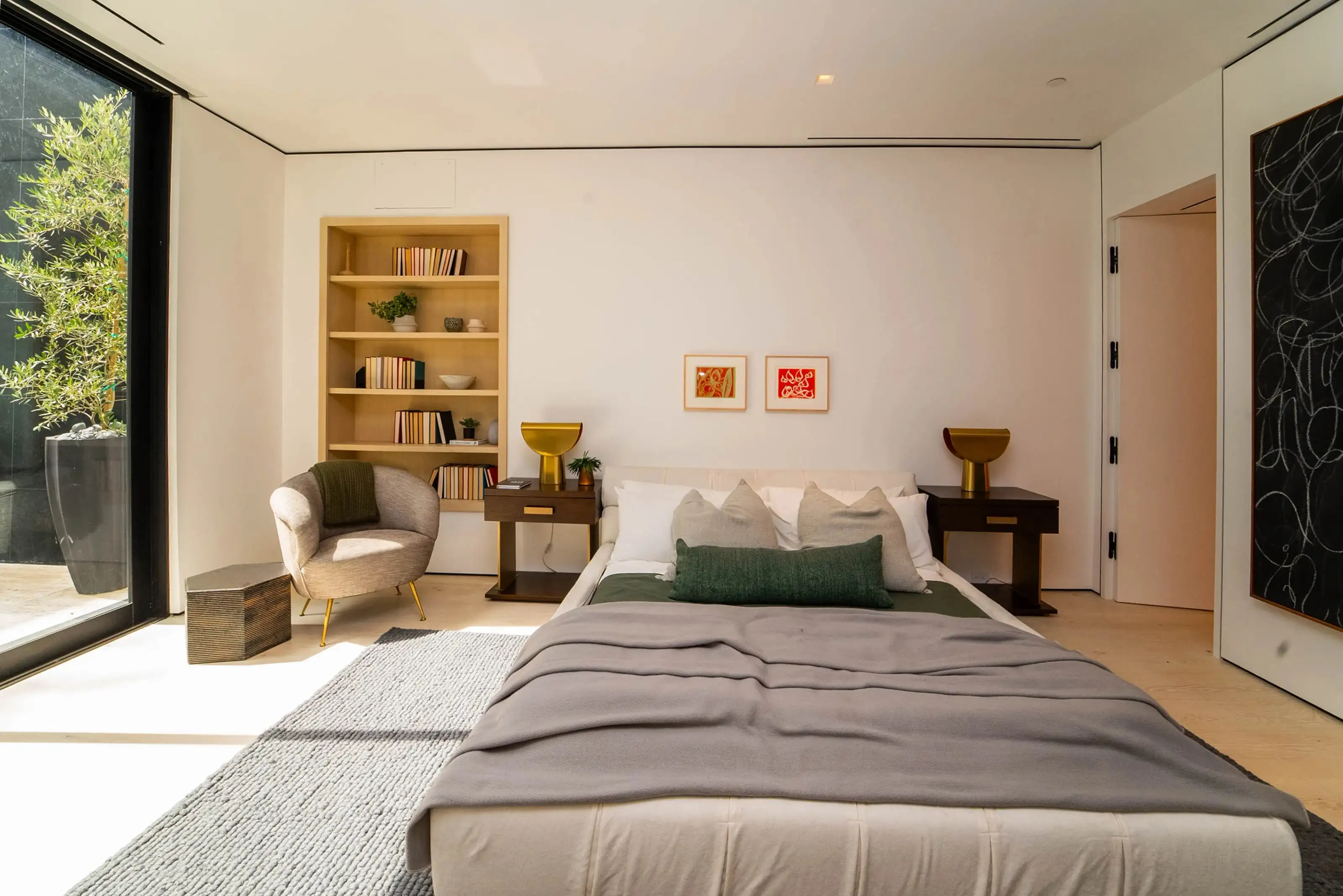 Modern bedroom design in San Jose with natural light, wood floors, and built-in shelves for a minimalist contemporary look.