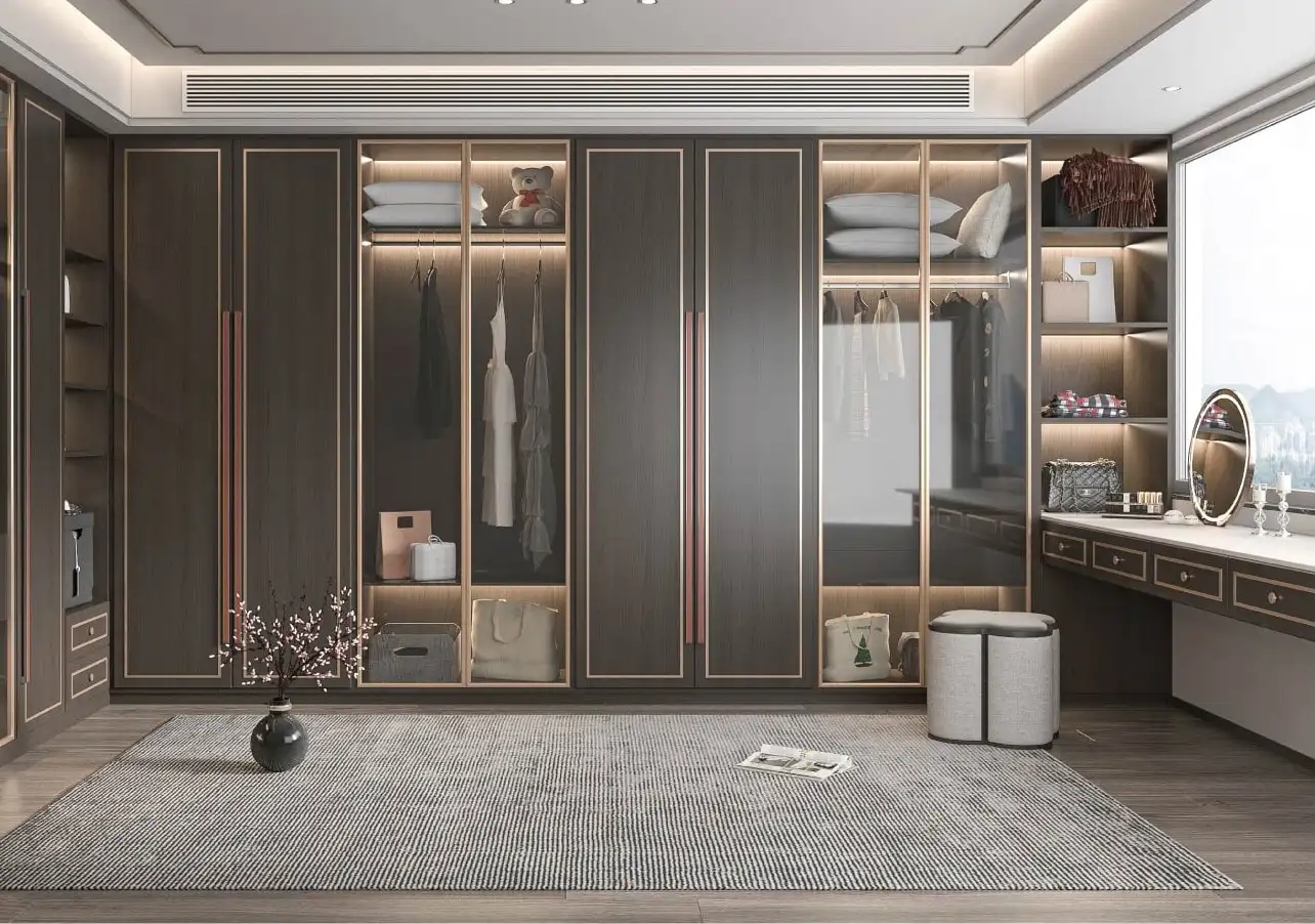 Dark bronze dressing room with glazed wardrobes, a dressing table and drawer banks
